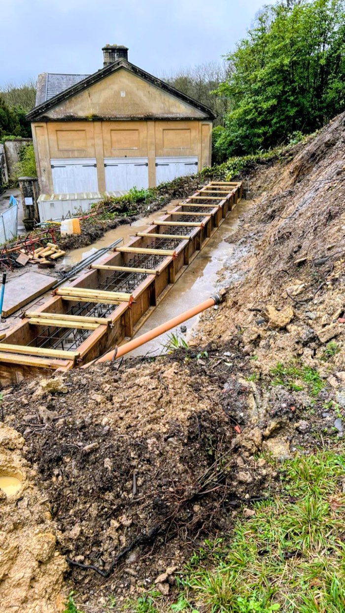 Freshly poured concrete being levelled by site team